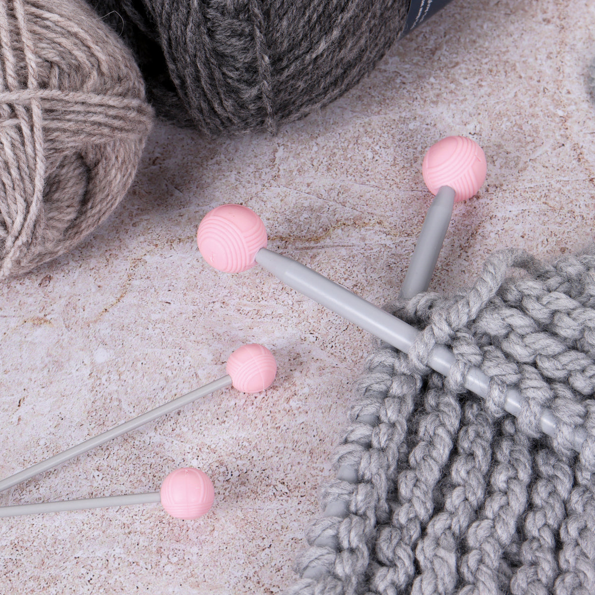 Four yarn ball shaped knitting needle point protectors