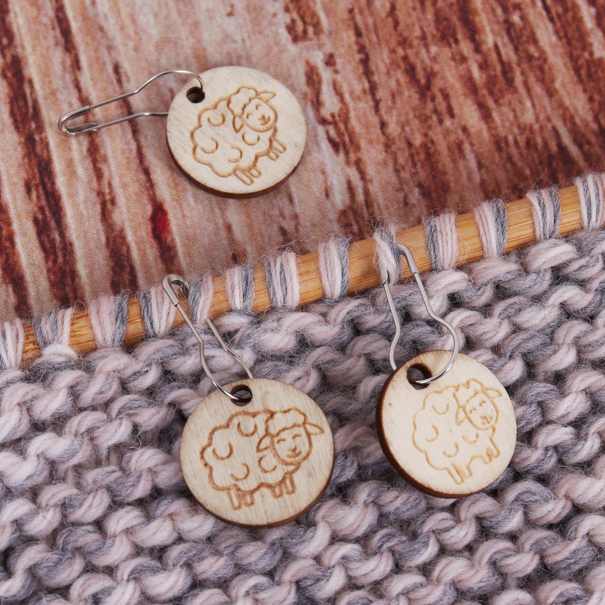 Tub of wooden sheep stitch markers on bulb pins