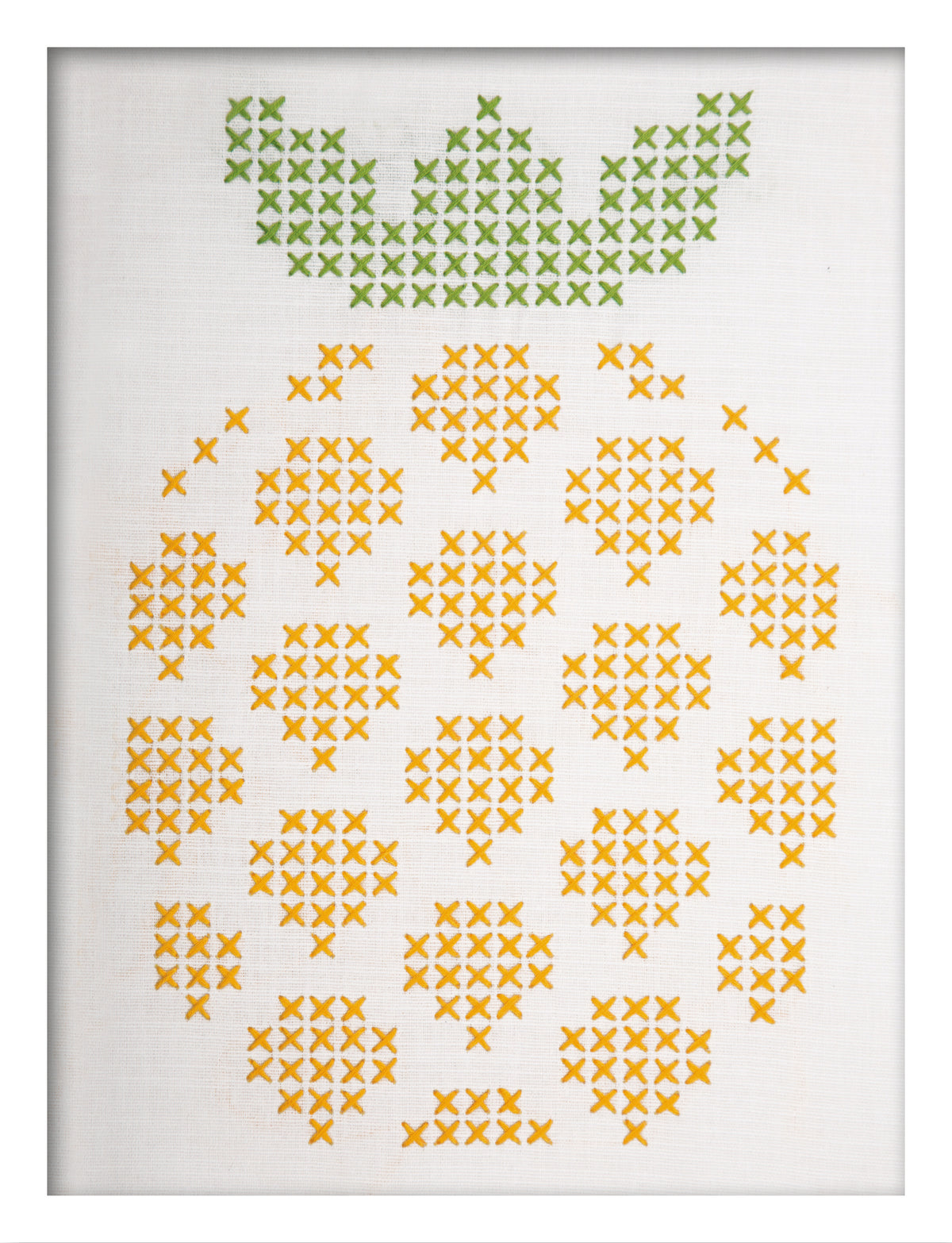 Embroidered pineapple design on white fabric