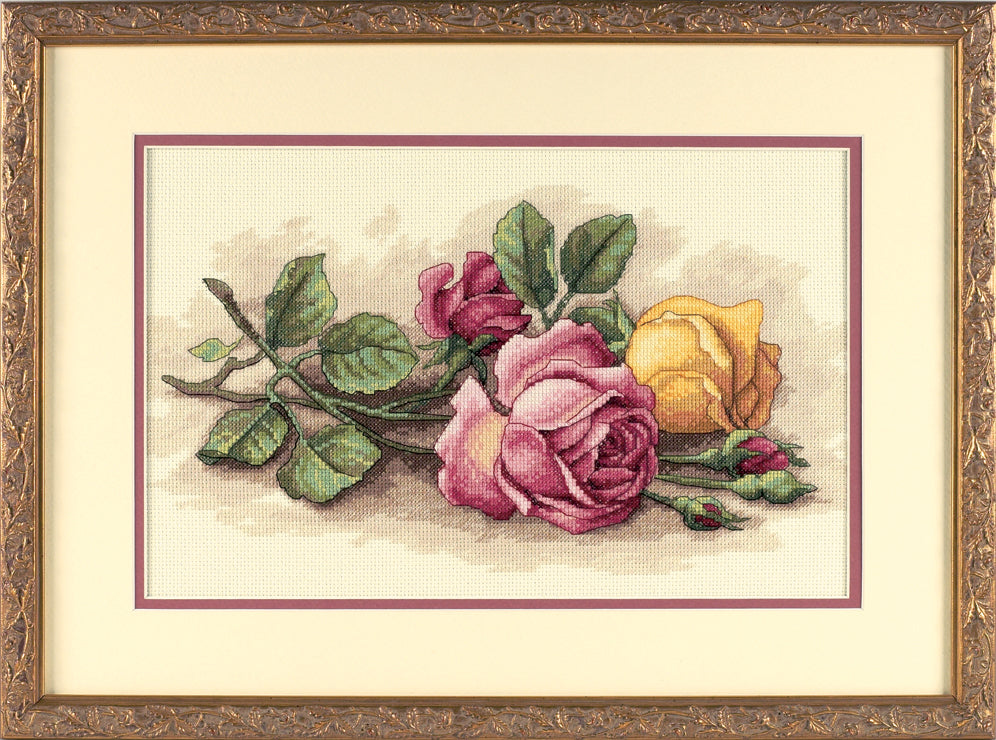 Finished cross stitch of cut roses on ivory fabric