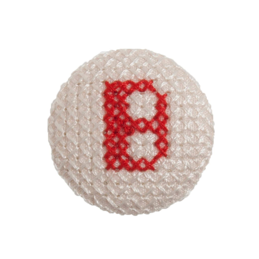Round button with a red cross-stitch letter B