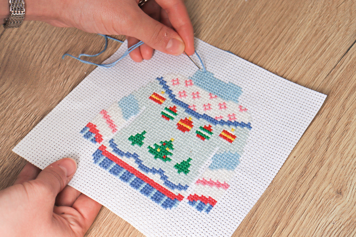 Trimits mini cross stitch kit showing a festive Christmas jumper