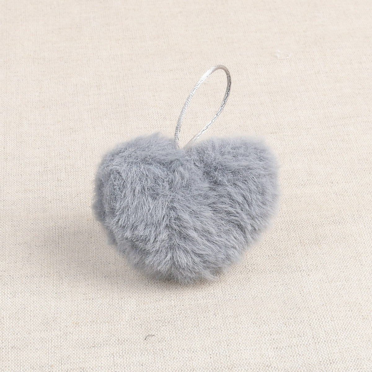 Grey faux fur heart-shaped pom pom with a hanging loop