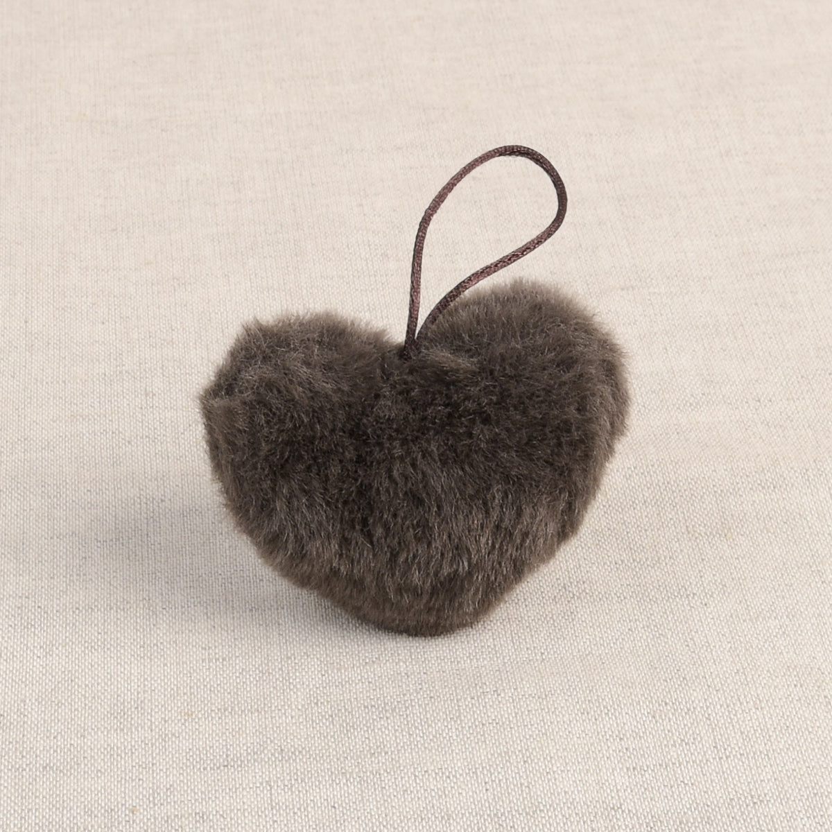 Brown faux fur heart-shaped pom pom with loop
