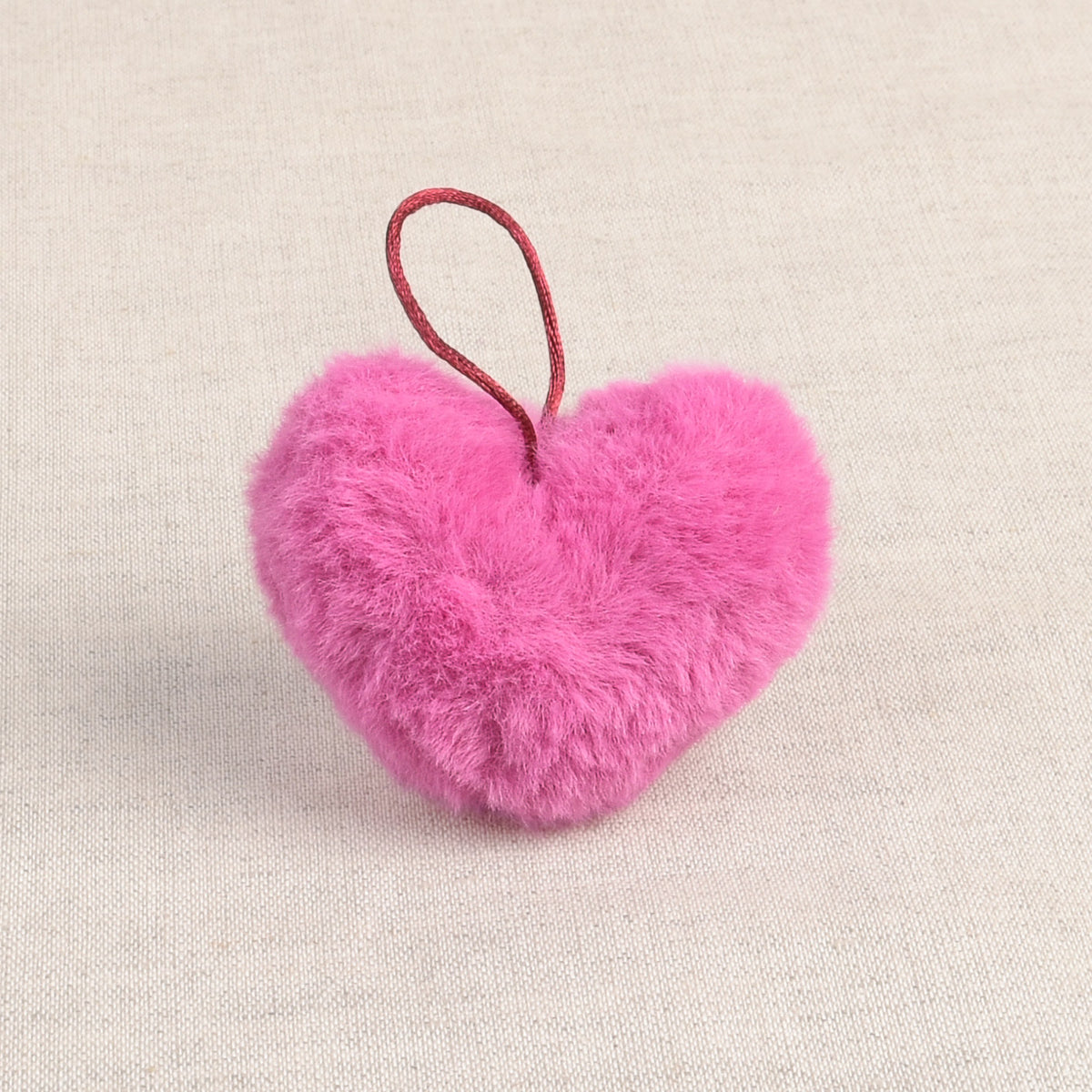 Neon Pink faux fur heart-shaped pom pom with loop