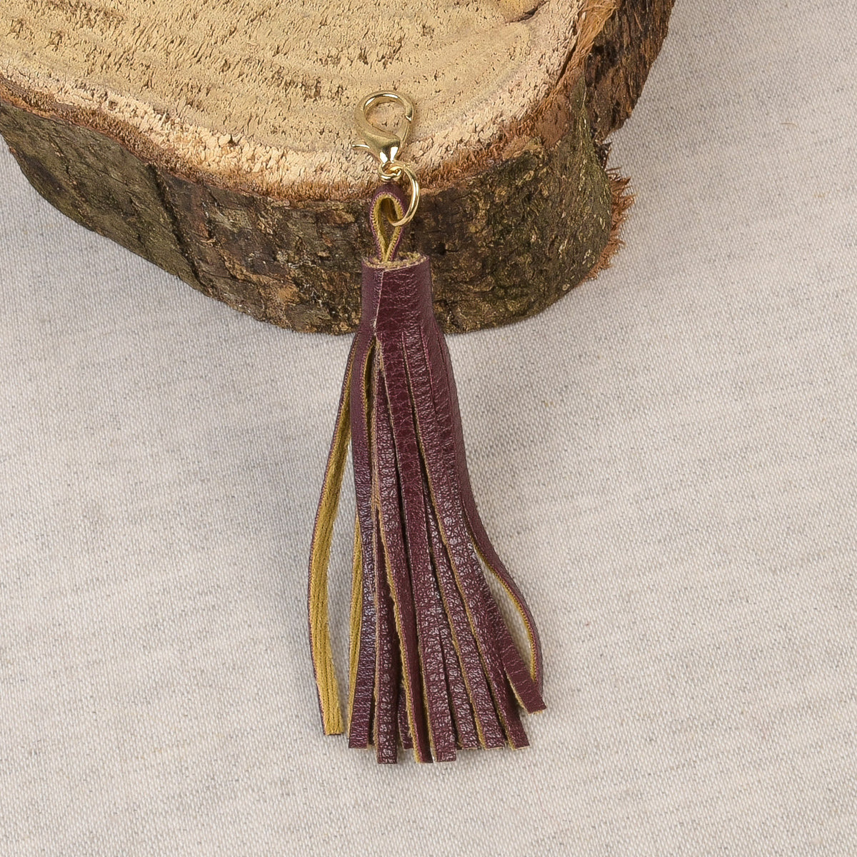 Burgundy tassel with a fastener at the top