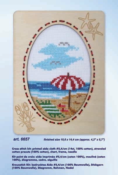 Orchidea cross stitch kit with a beach scene design in an engraved wooden frame