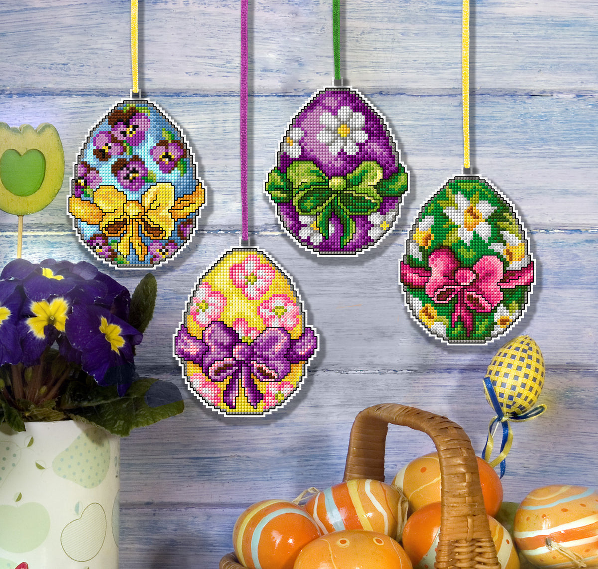 Set of 4 cross stitched easter egg decorations on white plastic canvas