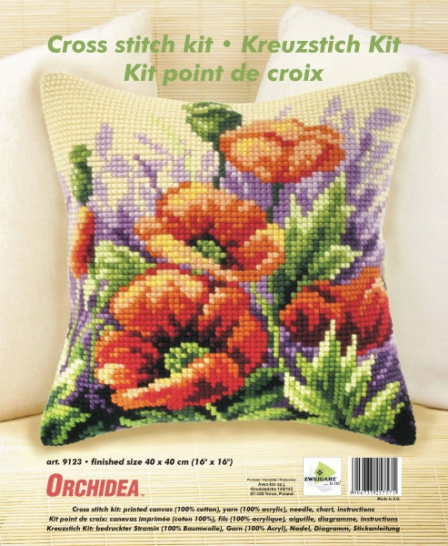 Cross stitched cushion with a poppies in meadow design