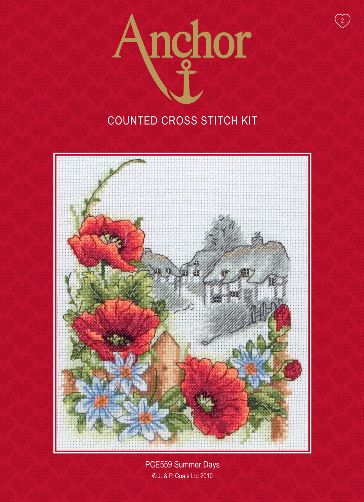 Anchor Summer Days cross stitch kit showing a village scene framed by poppies