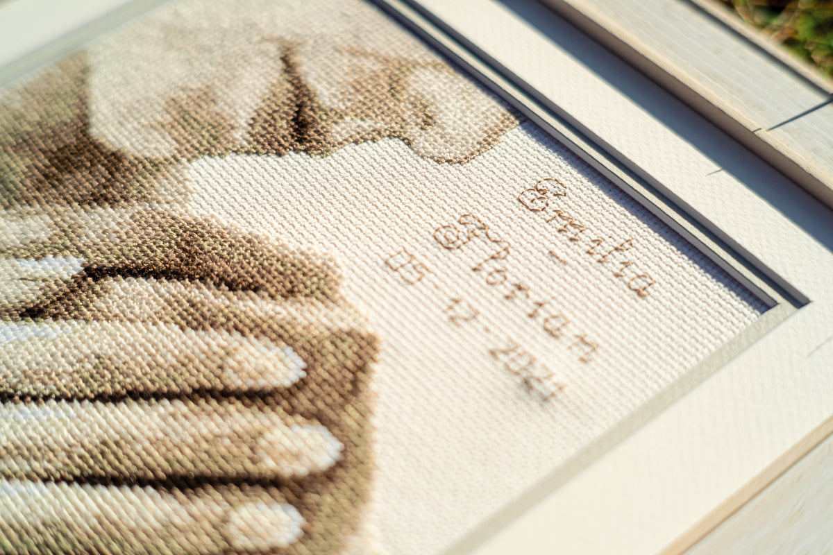 Cross stitch wedding record with joined hands
