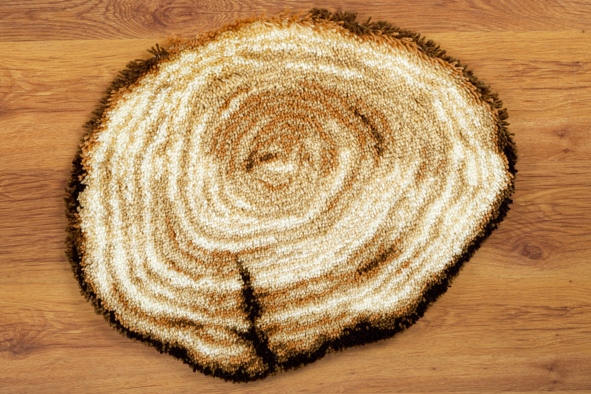 Latch hook shaped rug showing a tree stump