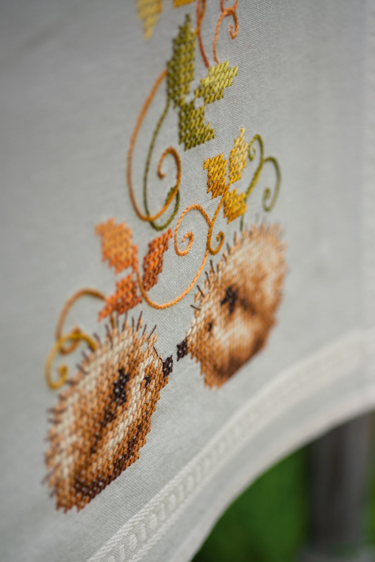 Embroidered table runner with hedgehogs and autumn leaves