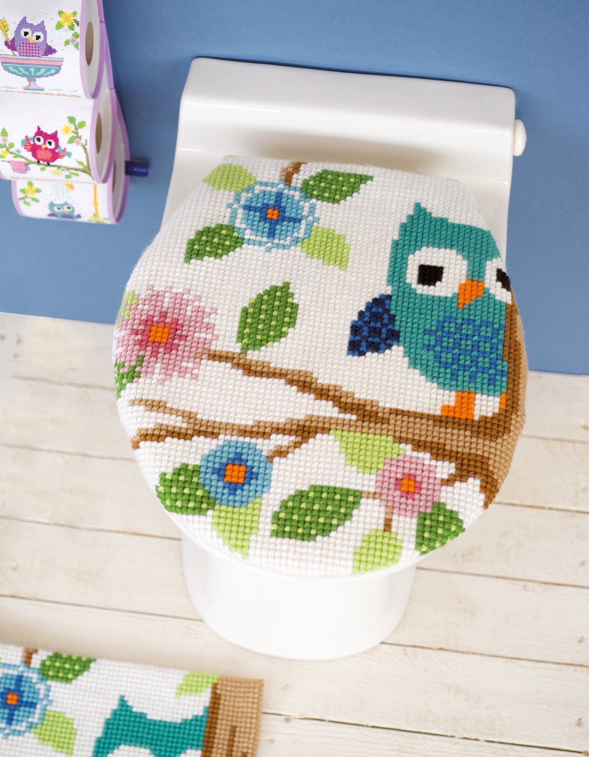 Stitched toilet lid cover with an owl sitting on a branch