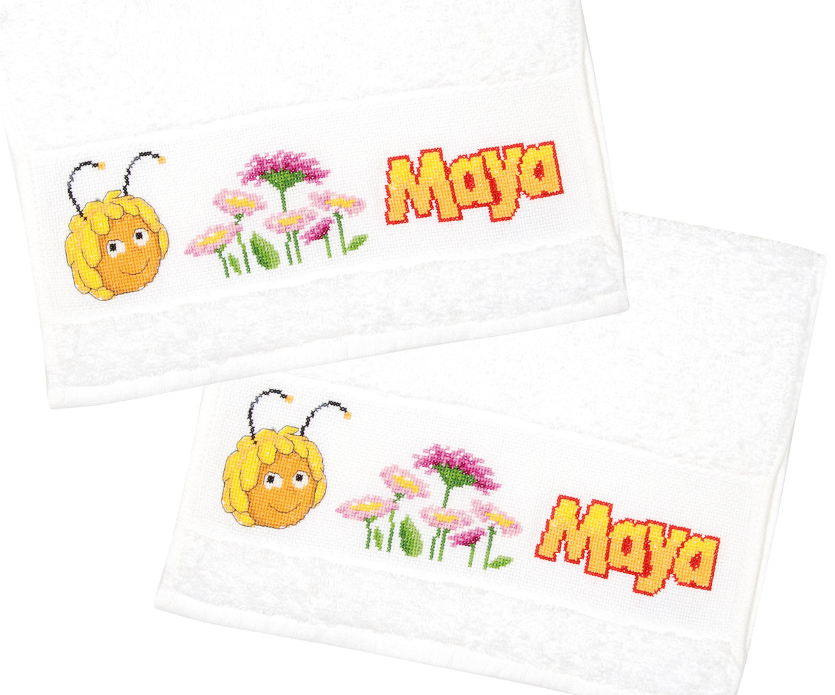 Two white towels with cross stitched Maya the Bee and flower borders