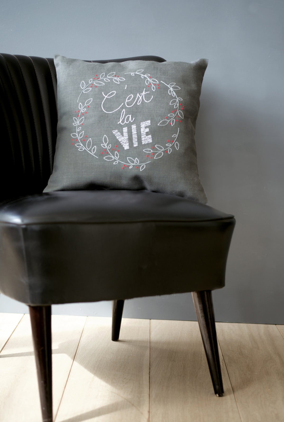 C'est La Vie embroidered cushion kit by Vervaco on dark grey fabric