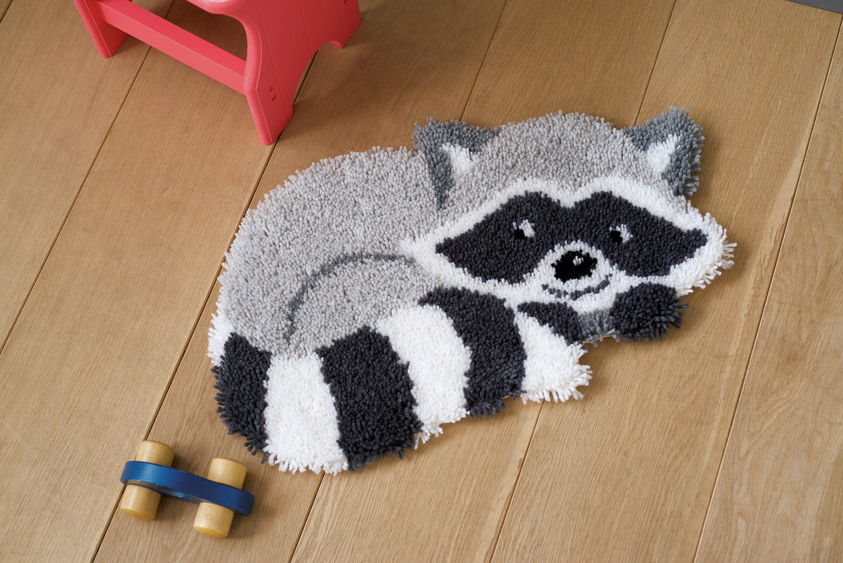 Latch hook rug shaped like a raccoon