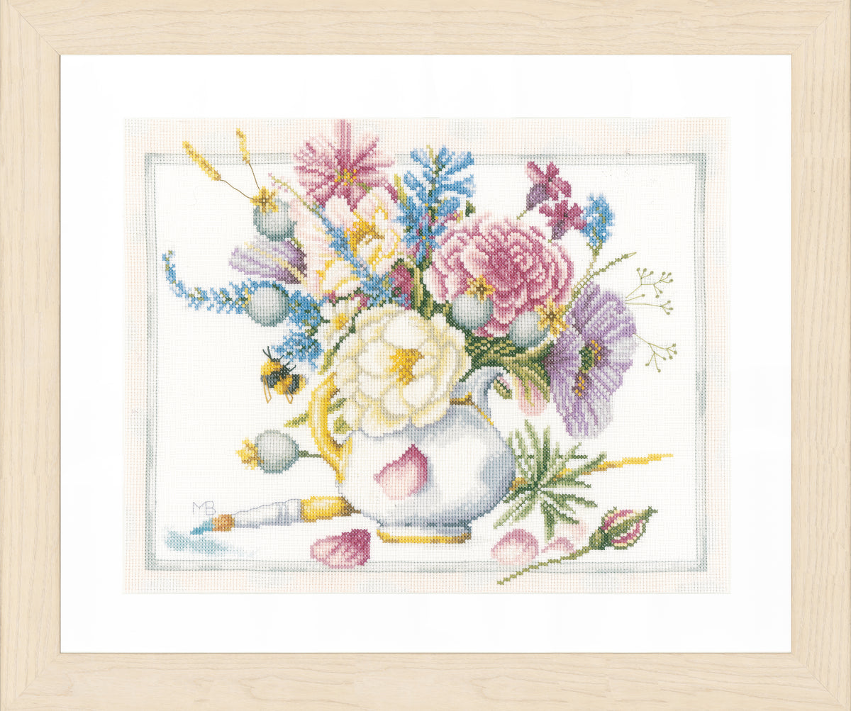 Cross stitched picture of colourful flowers in a white pot