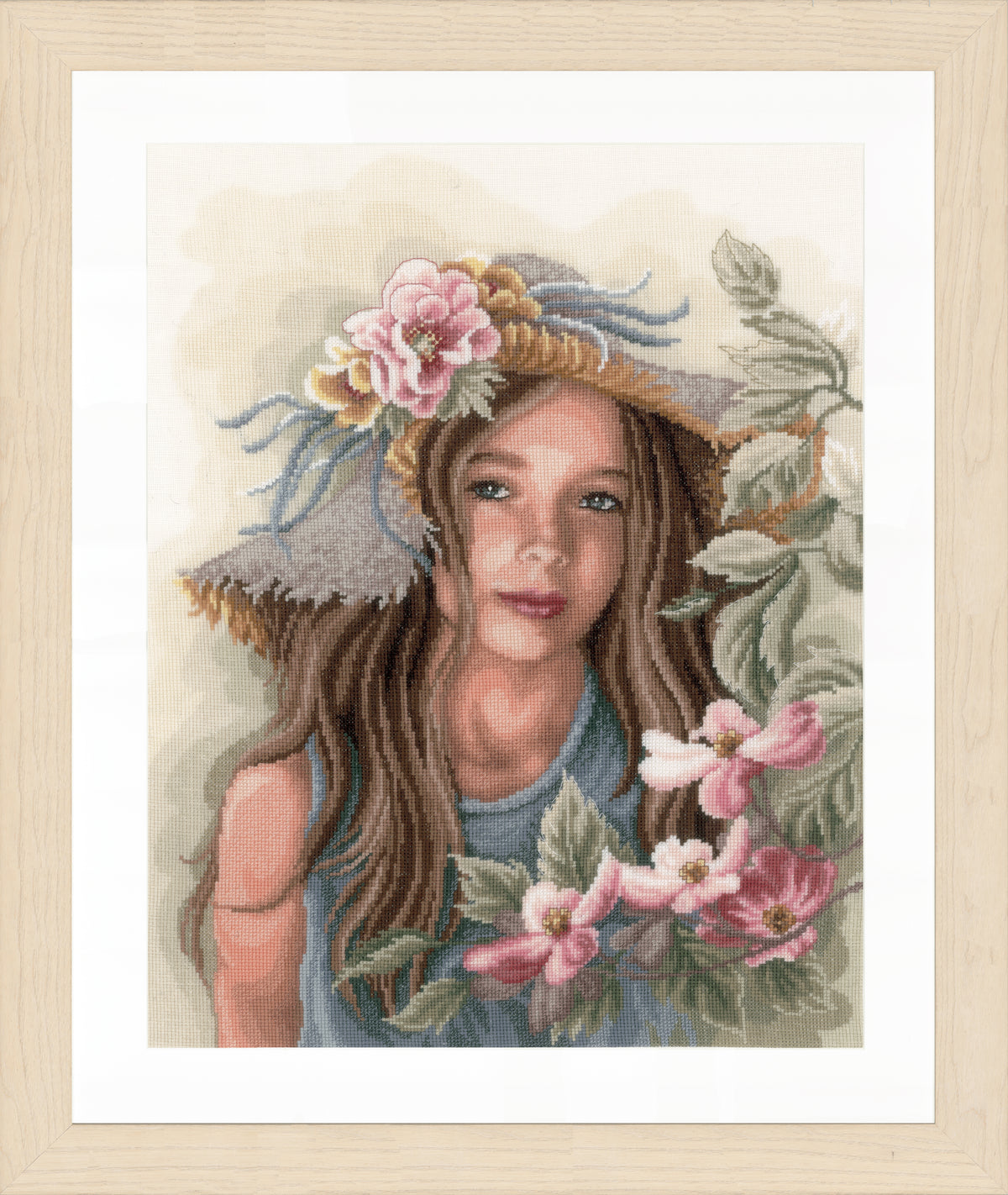 Cross stitched portrait of a little girl in a hat