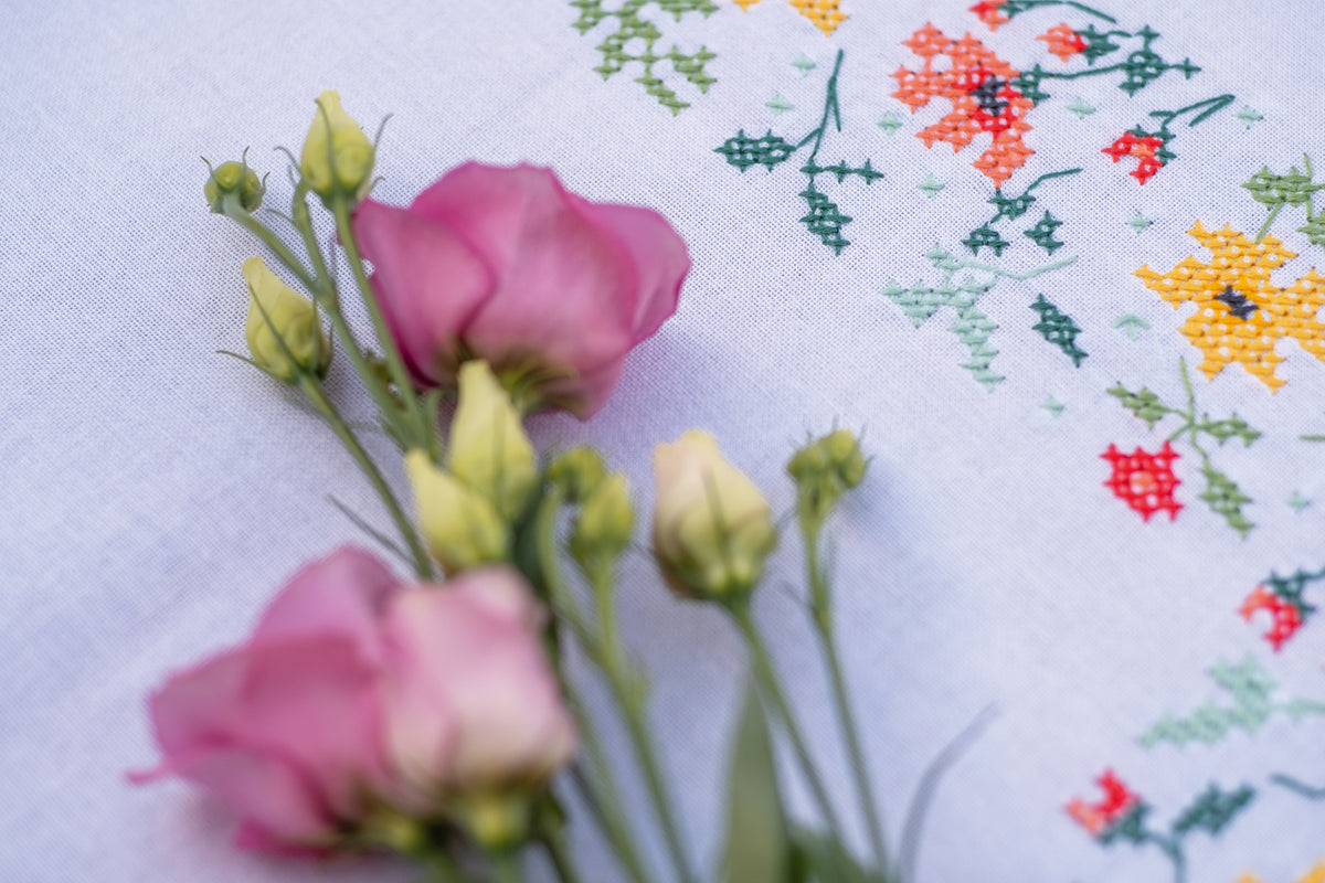 White tablecloth embroidered with fresh flowers