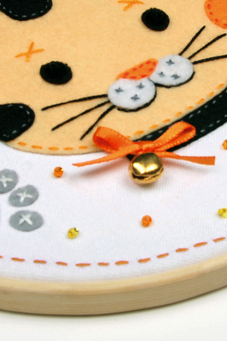 Felt kitten picture in a round hoop frame