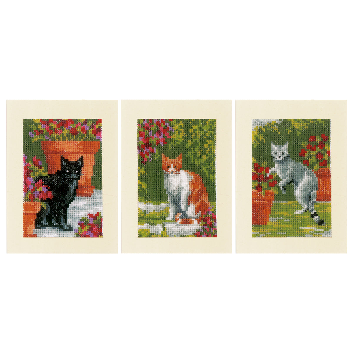 Three cross stitched greeting cards with cats and flowers