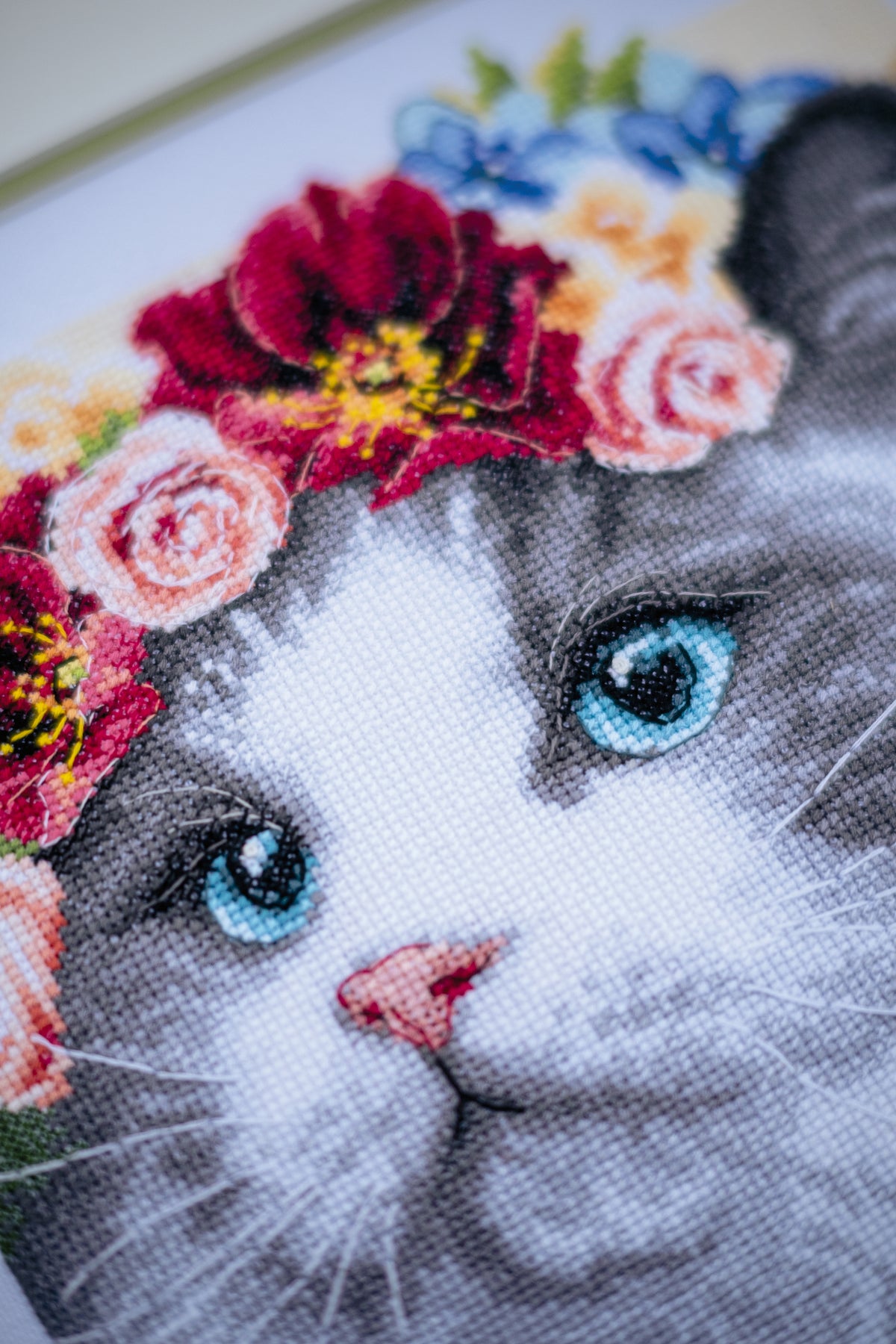 Cross stitch of a Ragdoll cat wearing a flower crown