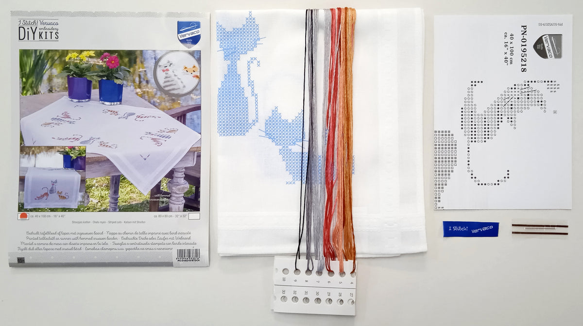 Embroidered table runner with a row of striped cats