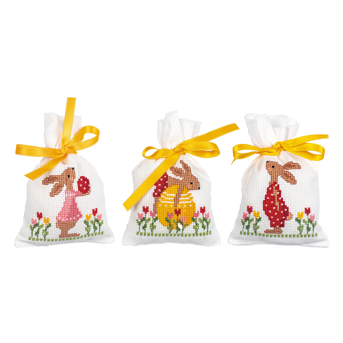 Three cross stitched drawstring bags with Easter rabbits