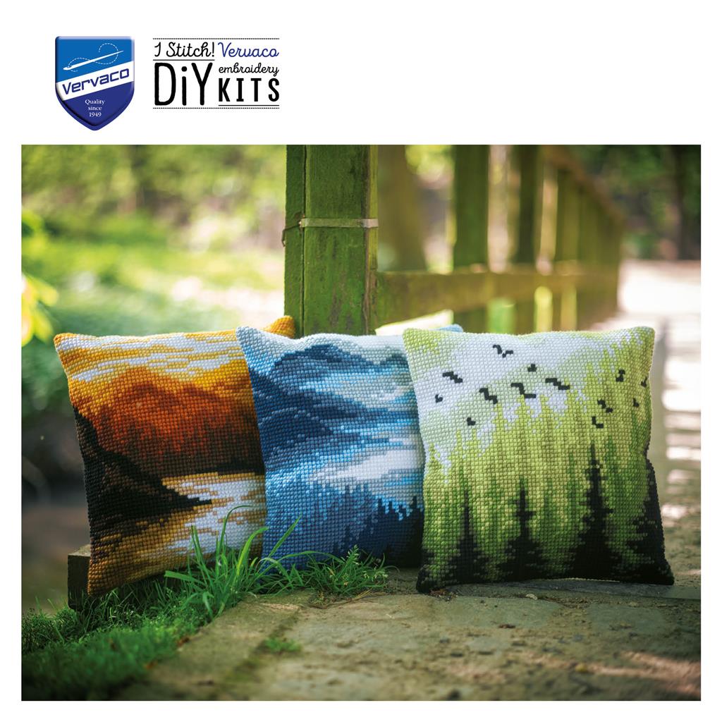 Cross stitch cushion with a mountain landscape design