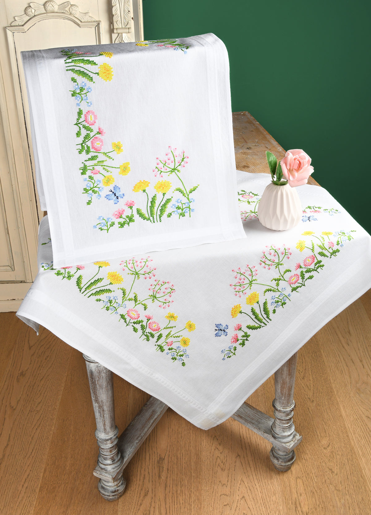 White table runner embroidered with colourful field flowers