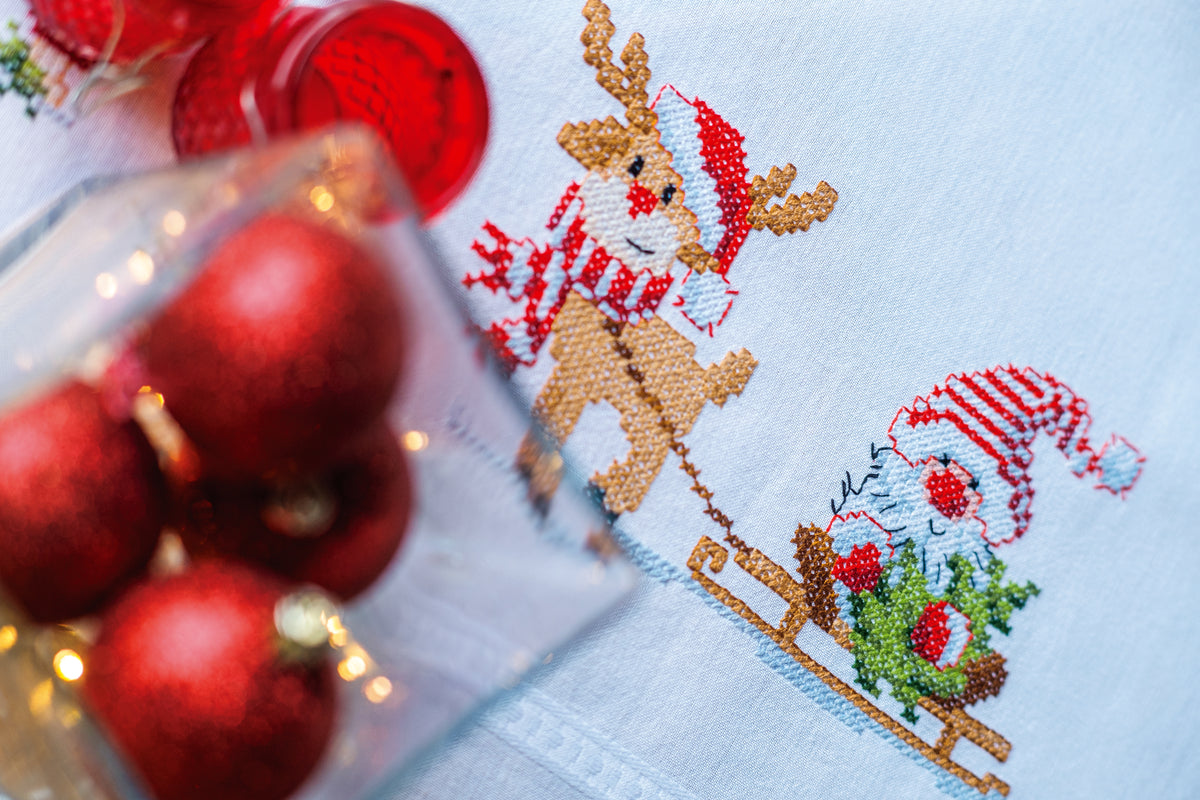 Embroidered tablecloth with gnome and reindeer motifs