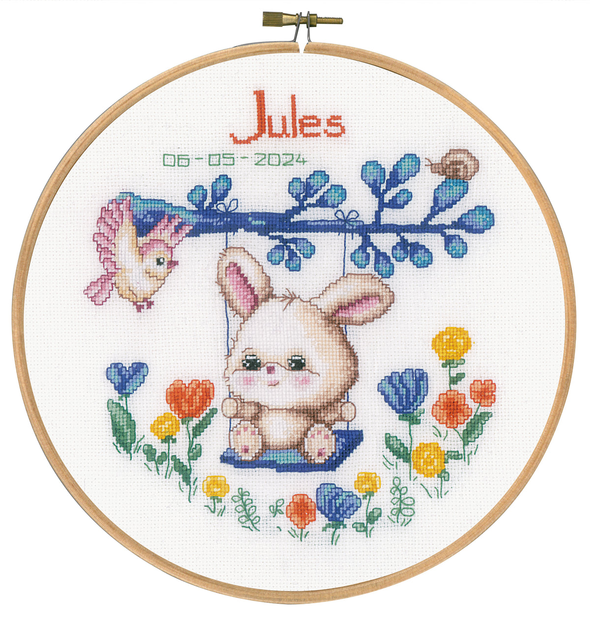 Cross stitch picture of a rabbit on a swing