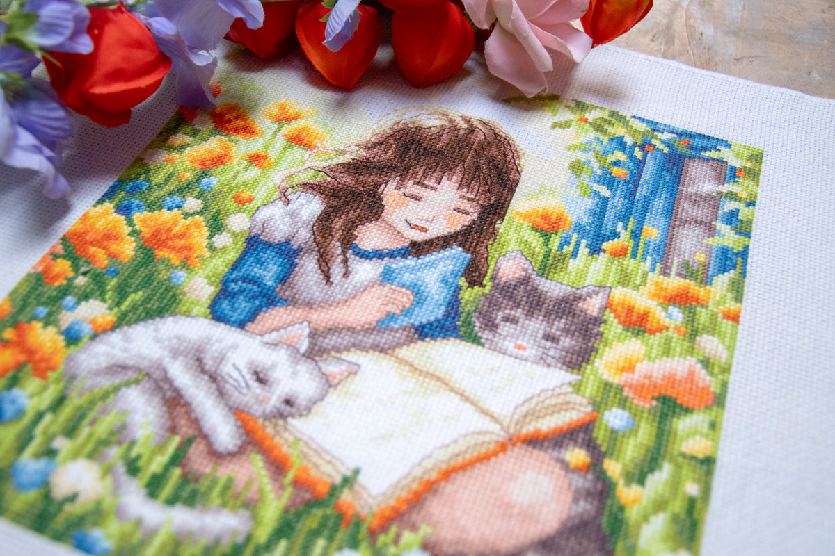 Cross stitch picture of a relaxing garden scene