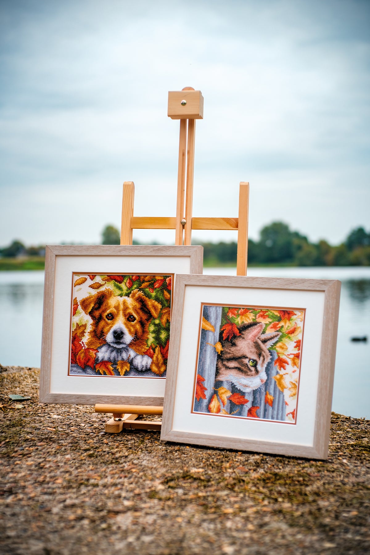 Cross stitch picture of a dog among autumn leaves