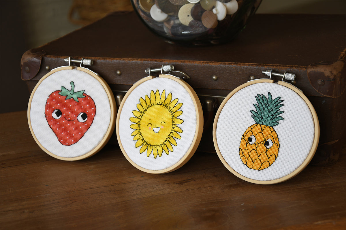 Eva Mouton sunflower cross stitch design in an embroidery hoop