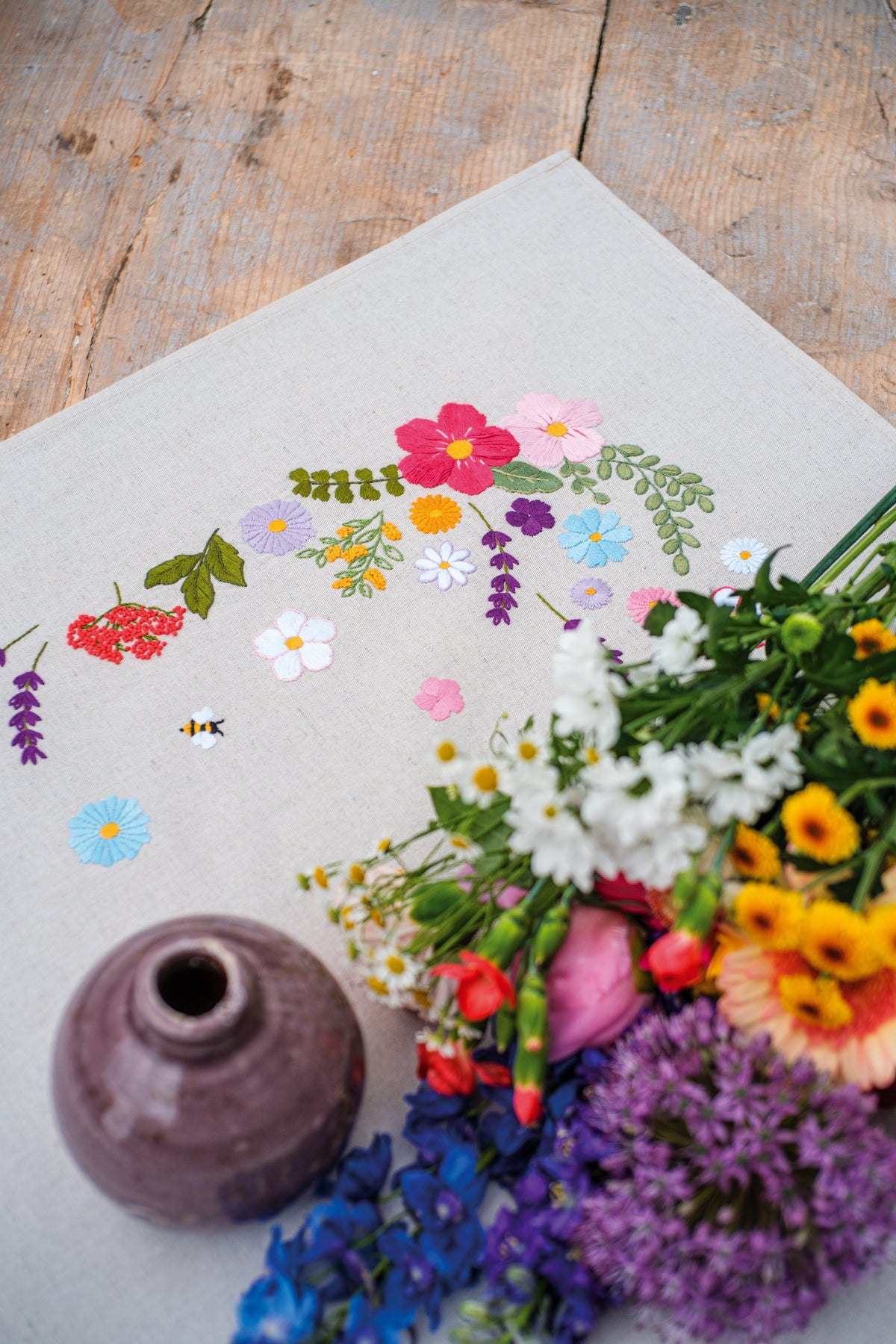 Embroidered tablecloth with cheerful spring floral design