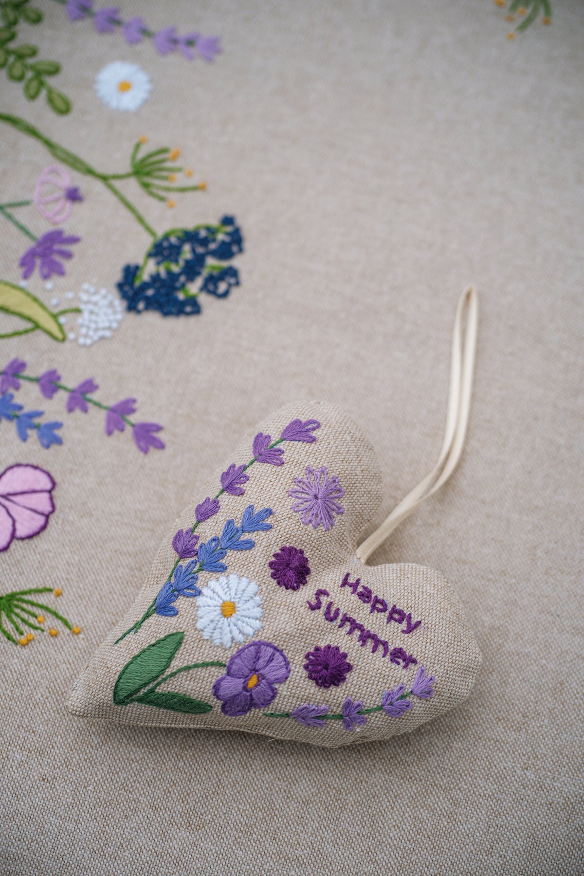 Small embroidered fabric heart with summer flowers