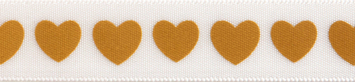 Reel of narrow white satin ribbon printed with cream hearts