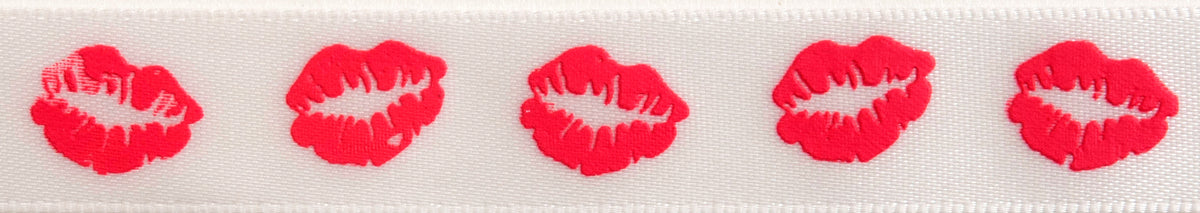 Close-up of lips print ribbon in hot pink on white