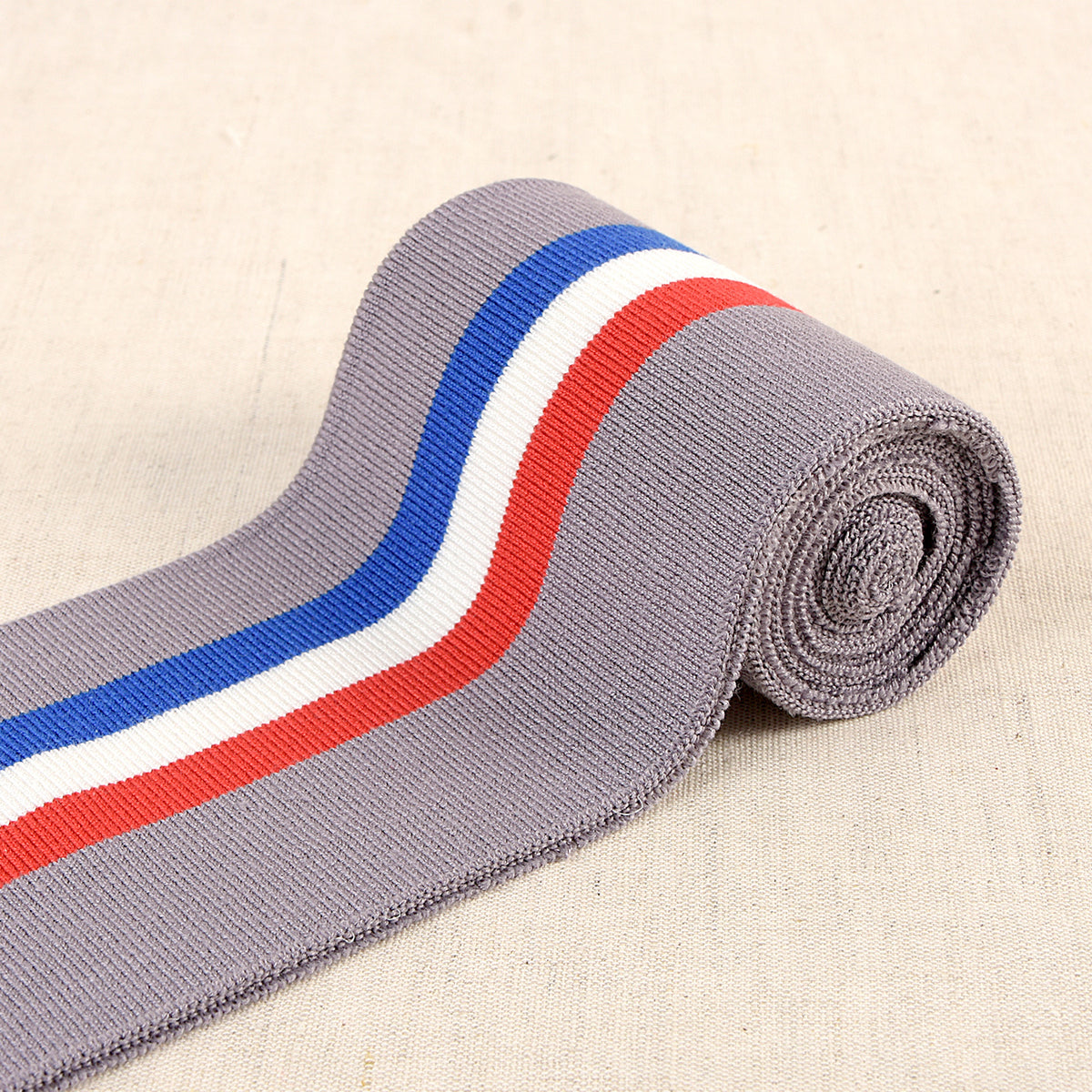 Grey cuff and waistband elastic with blue, white and red stripes