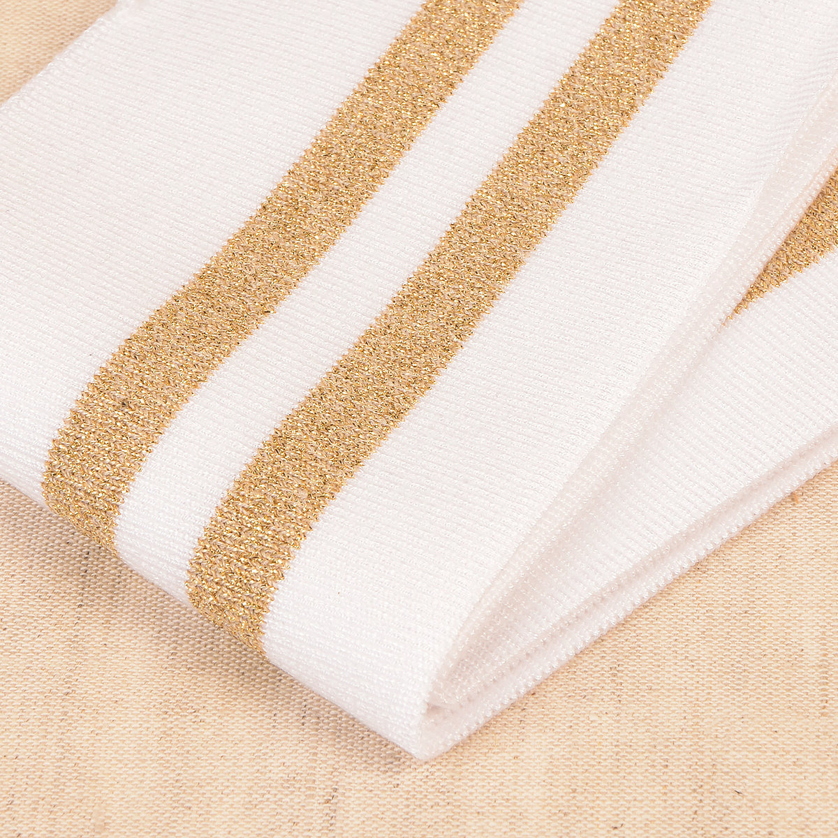 White cuff and waistband trim with gold metallic stripes
