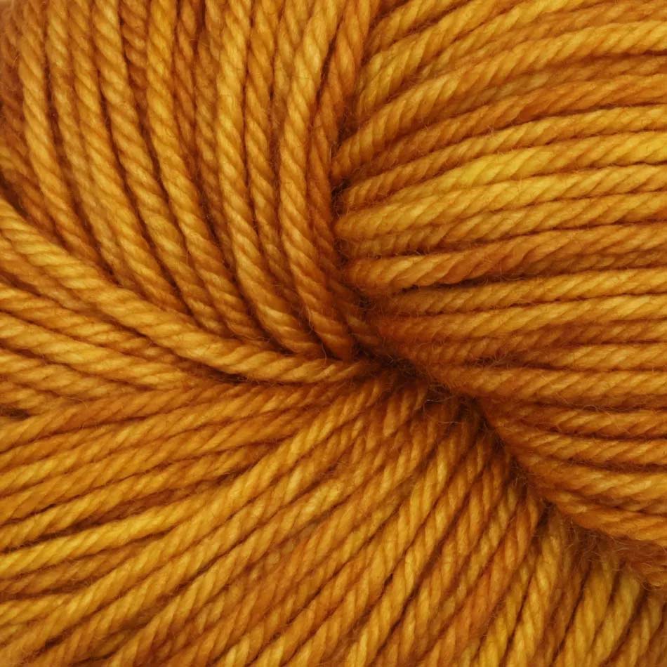 Skein of Symfonie Bella variegated merino yarn in Gold Leaf