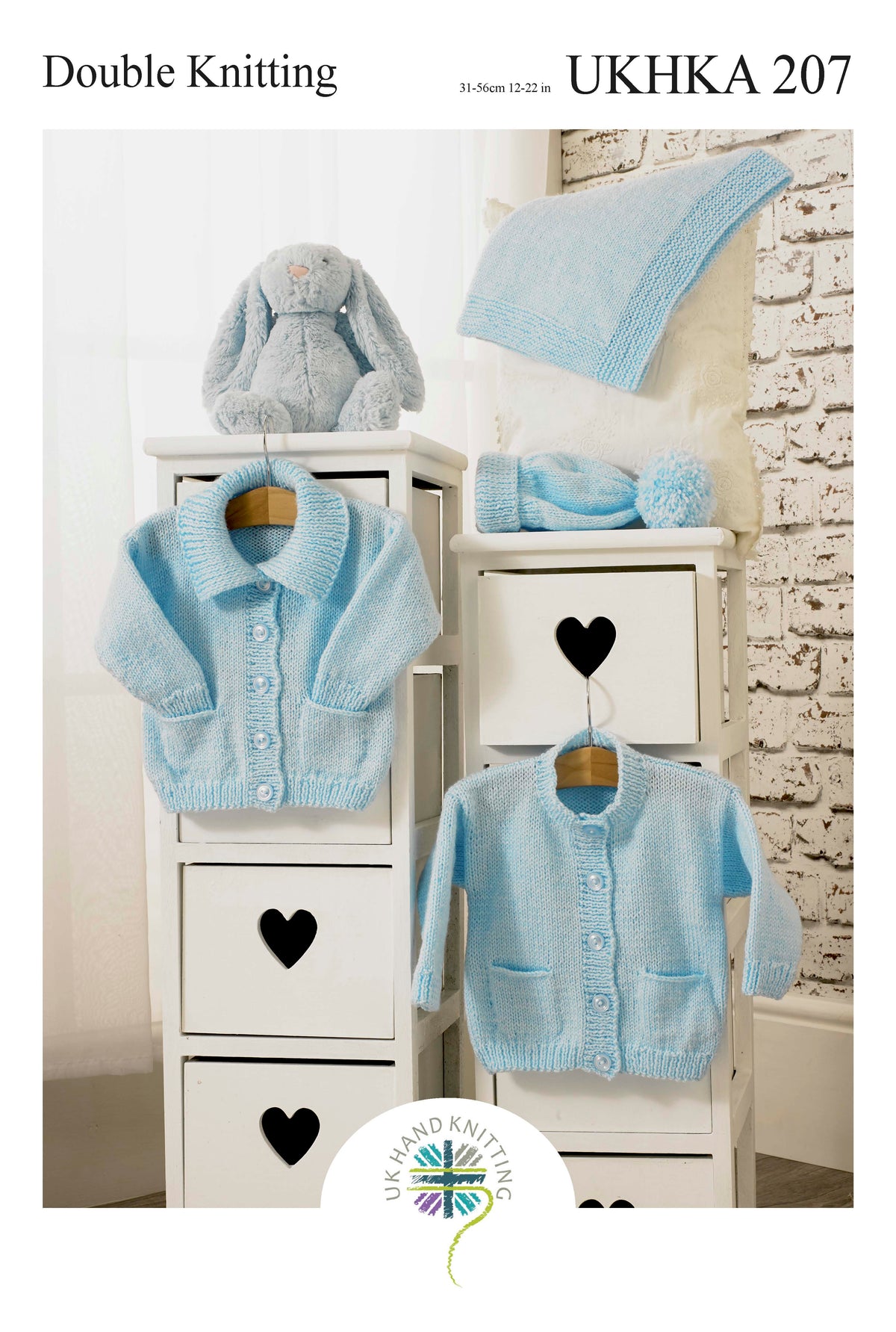 Cover of a UK Hand Knitting Association knitting pattern showing baby cardigans, a hat and a blanket
