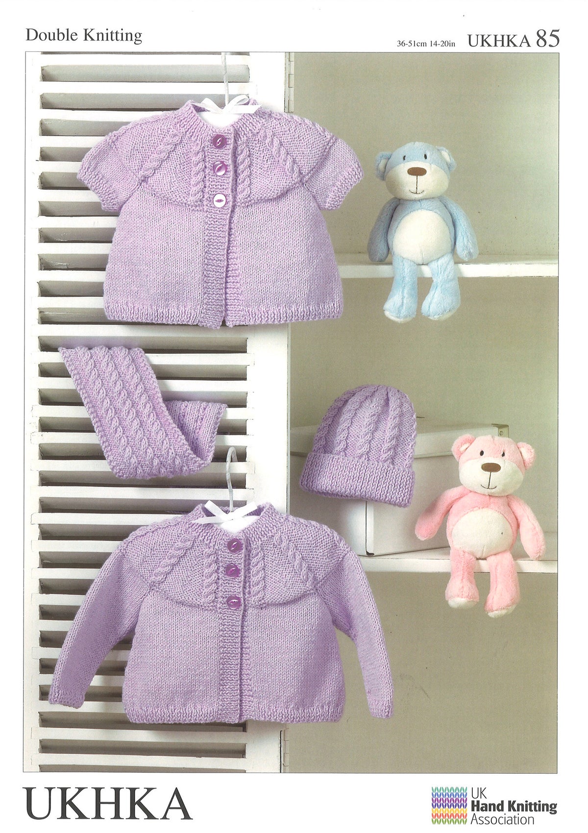 Cover of a UK Hand Knitting Association knitting pattern showing baby cardigans, a scarf and a hat