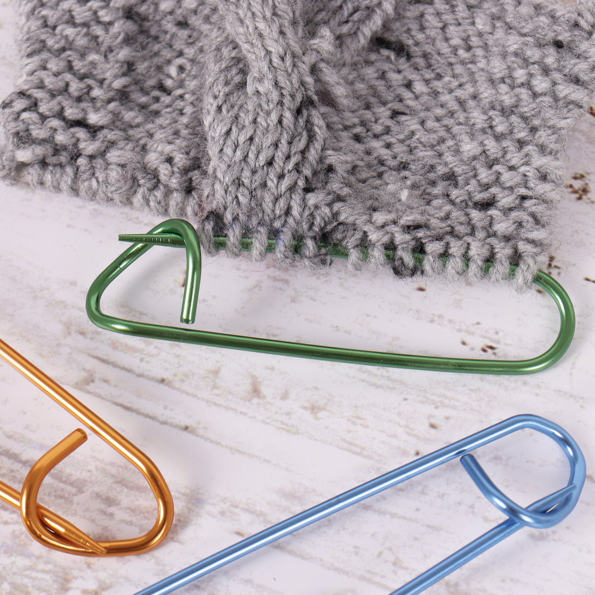 Three coloured aluminium stitch holders in different sizes
