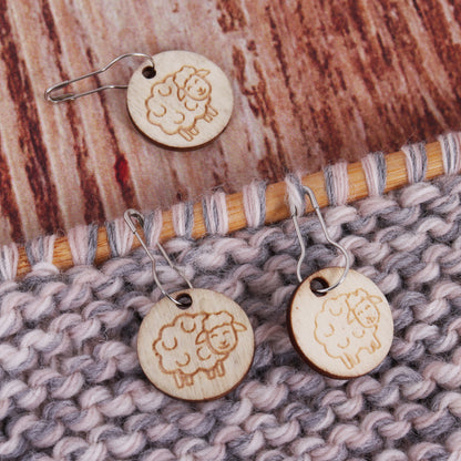 Tub of wooden sheep stitch markers on bulb pins