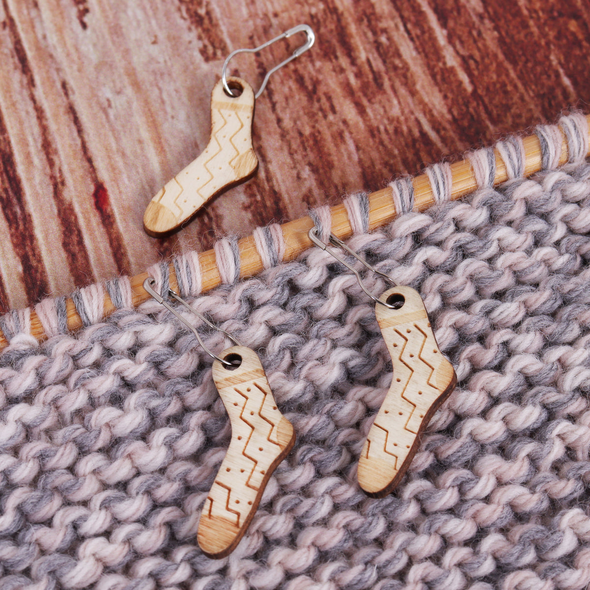 Tub of wooden woolly sock stitch markers on bulb pins