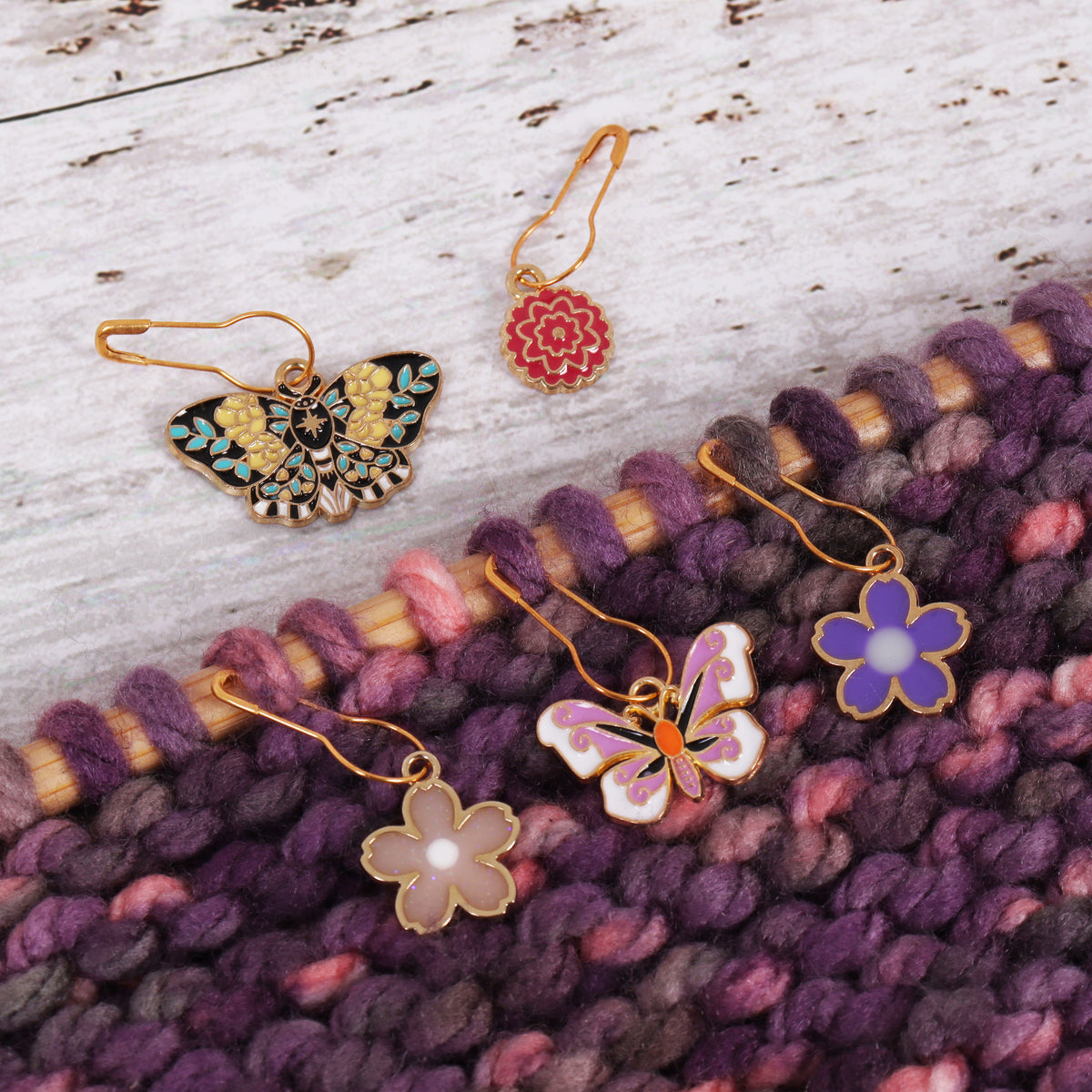 Tub of butterfly garden themed enamel charm stitch markers