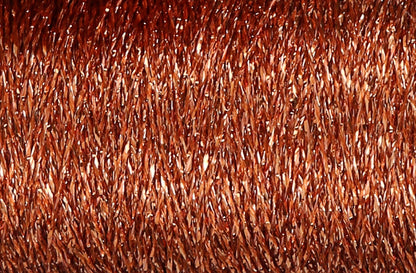 Close-up of copper metallic thread wound on a spool